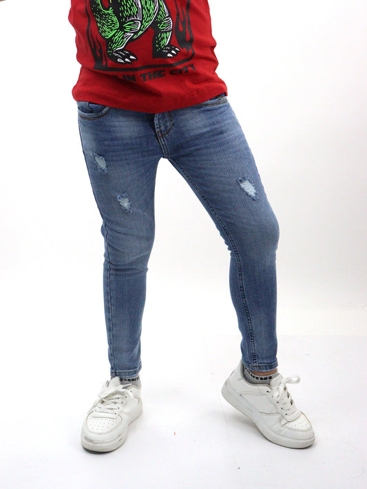 Jeans skinny de color azul medio con destrucción