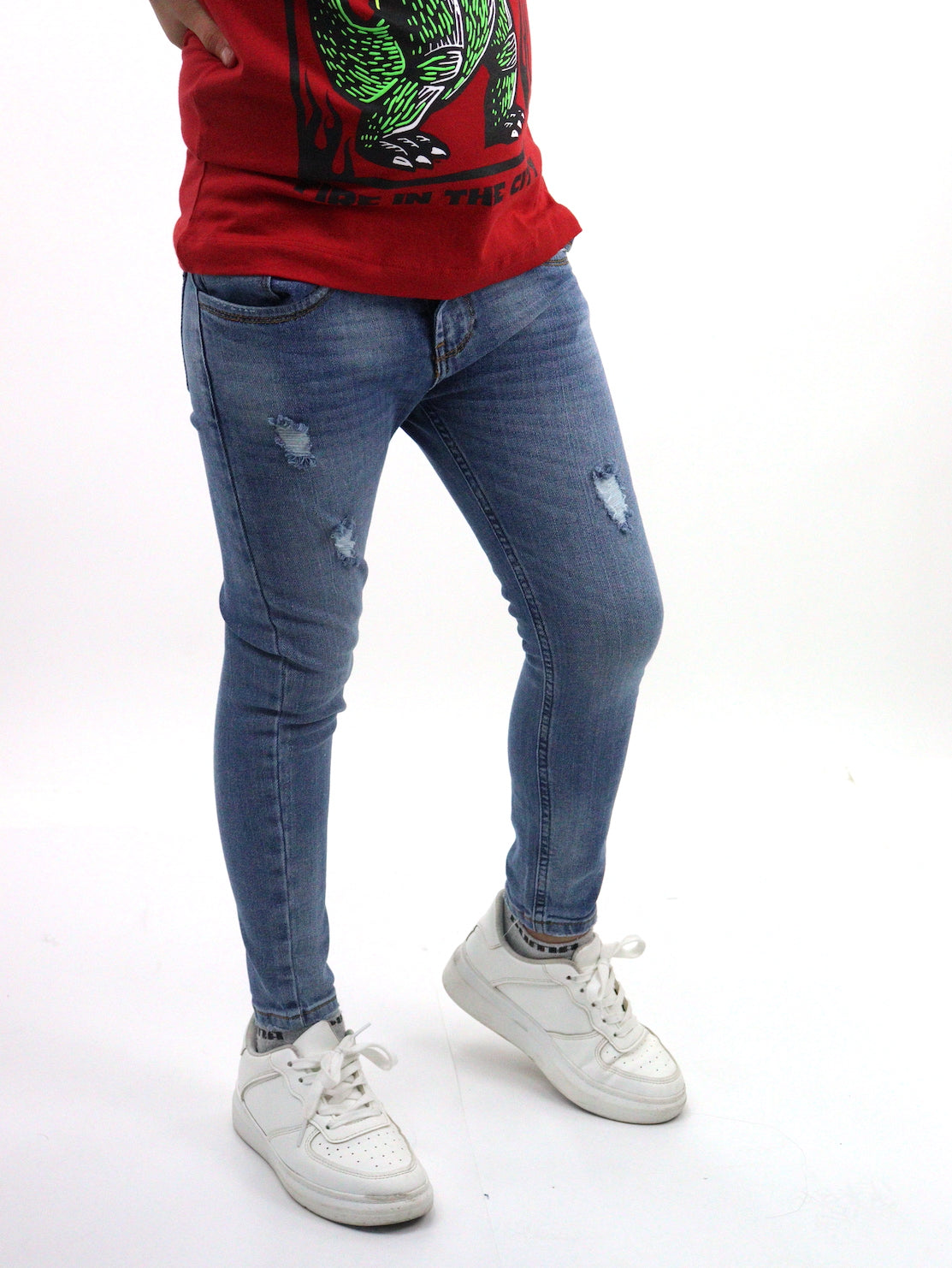 Jeans skinny de color azul medio con destrucción