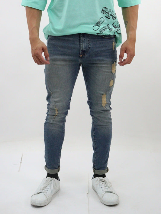 Jeans skinny de color azul deslavado con tinta y destrucción  (NUEVA TEMPORADA)