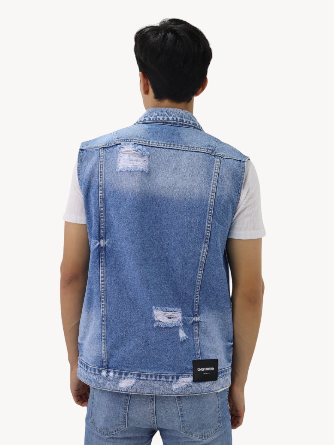 Chaleco denim de color azul medio con destrucción