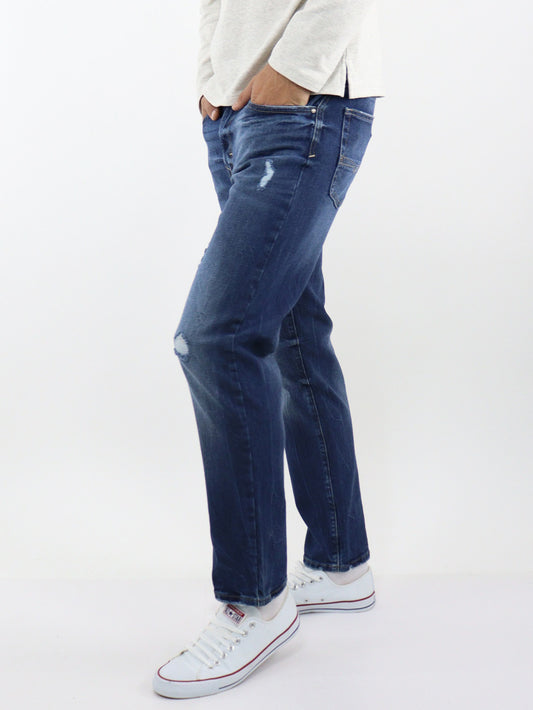 Jeans slim fit azul oscuro con destrucción