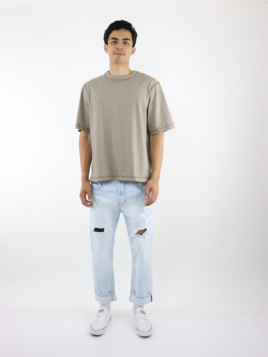 Jeans slim con destrucción