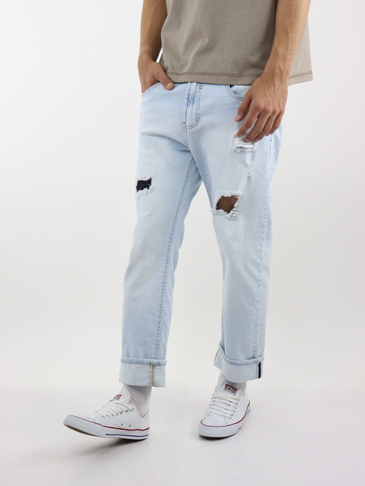 Jeans slim con destrucción