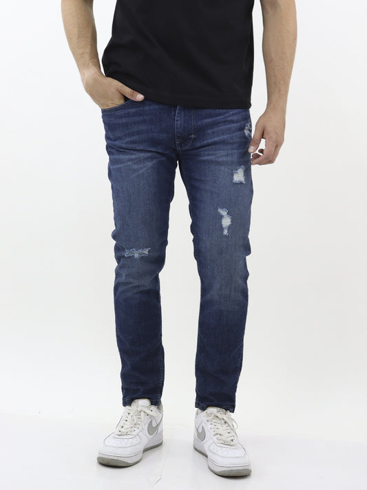 Jeans skinny fit con destrucción