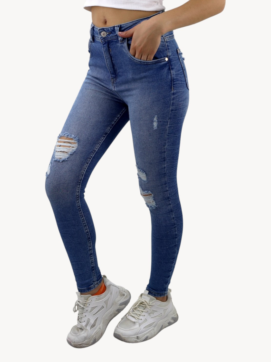 Jeans skinny tiro alto de color azul medio con destrucción
