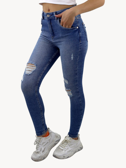 Jeans skinny tiro alto de color azul medio con destrucción