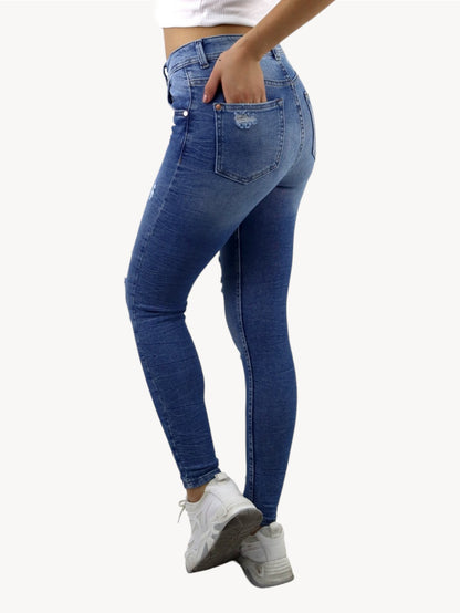 Jeans skinny tiro alto de color azul medio con destrucción