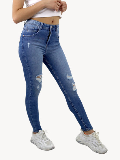 Jeans skinny tiro alto de color azul medio con destrucción