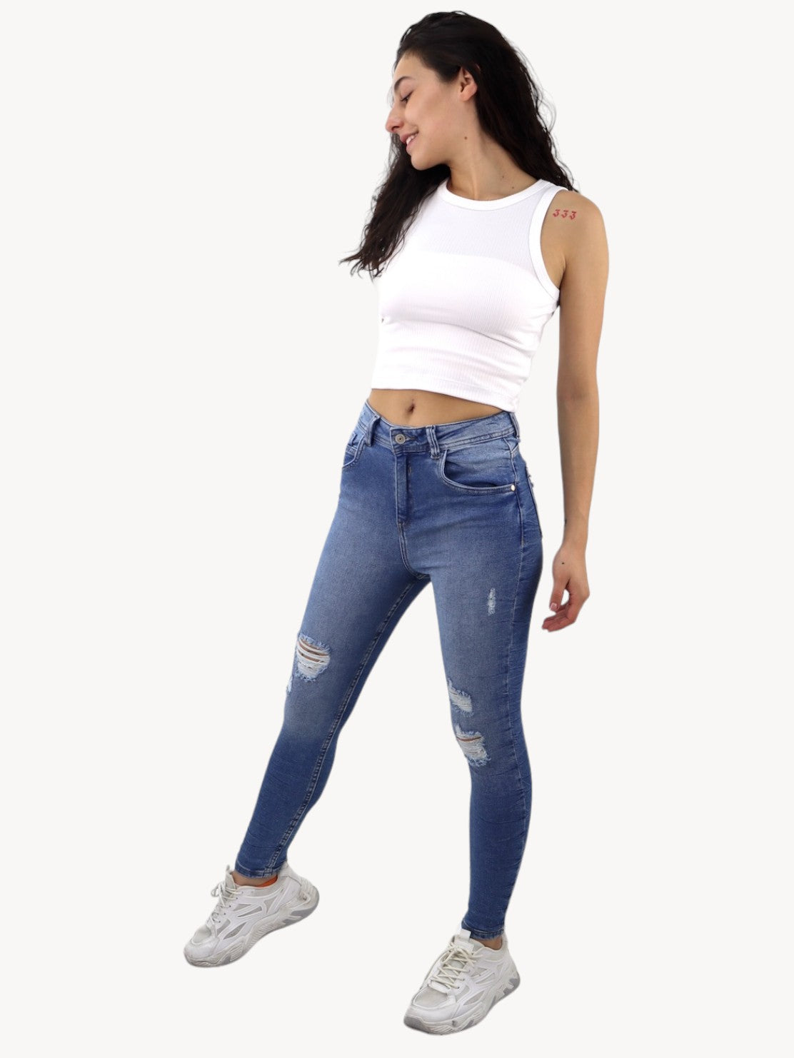 Jeans skinny tiro alto de color azul medio con destrucción