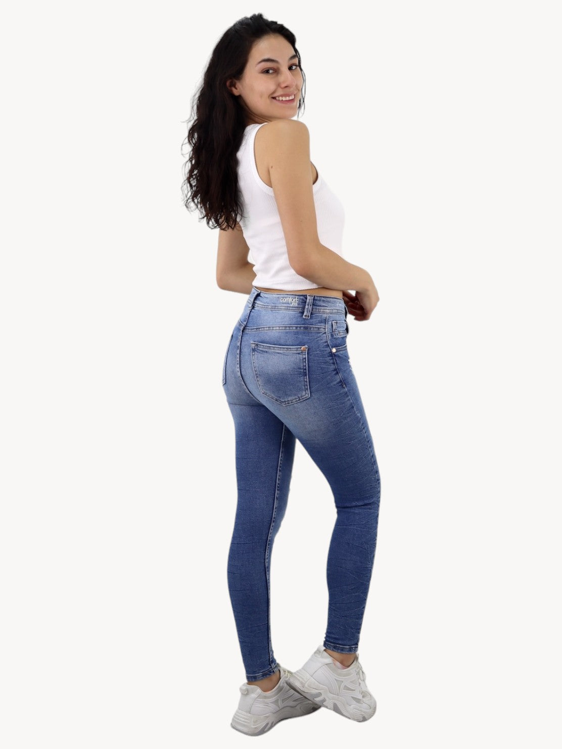 Jeans skinny tiro alto de color azul medio con destrucción
