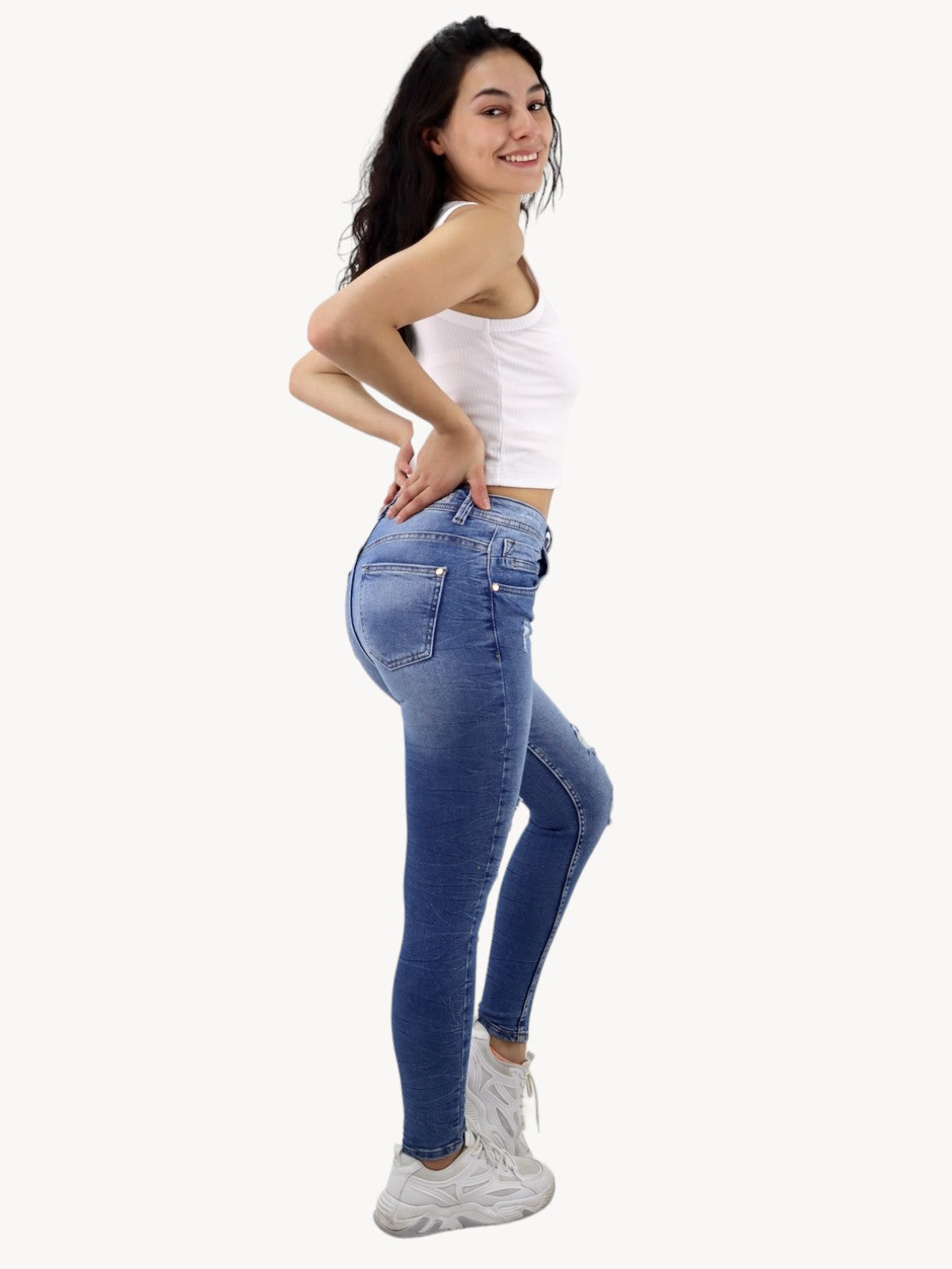 Jeans skinny tiro alto de color azul medio con destrucción