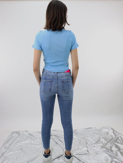Jeans skinny tiro alto de color azul medio con destrucción