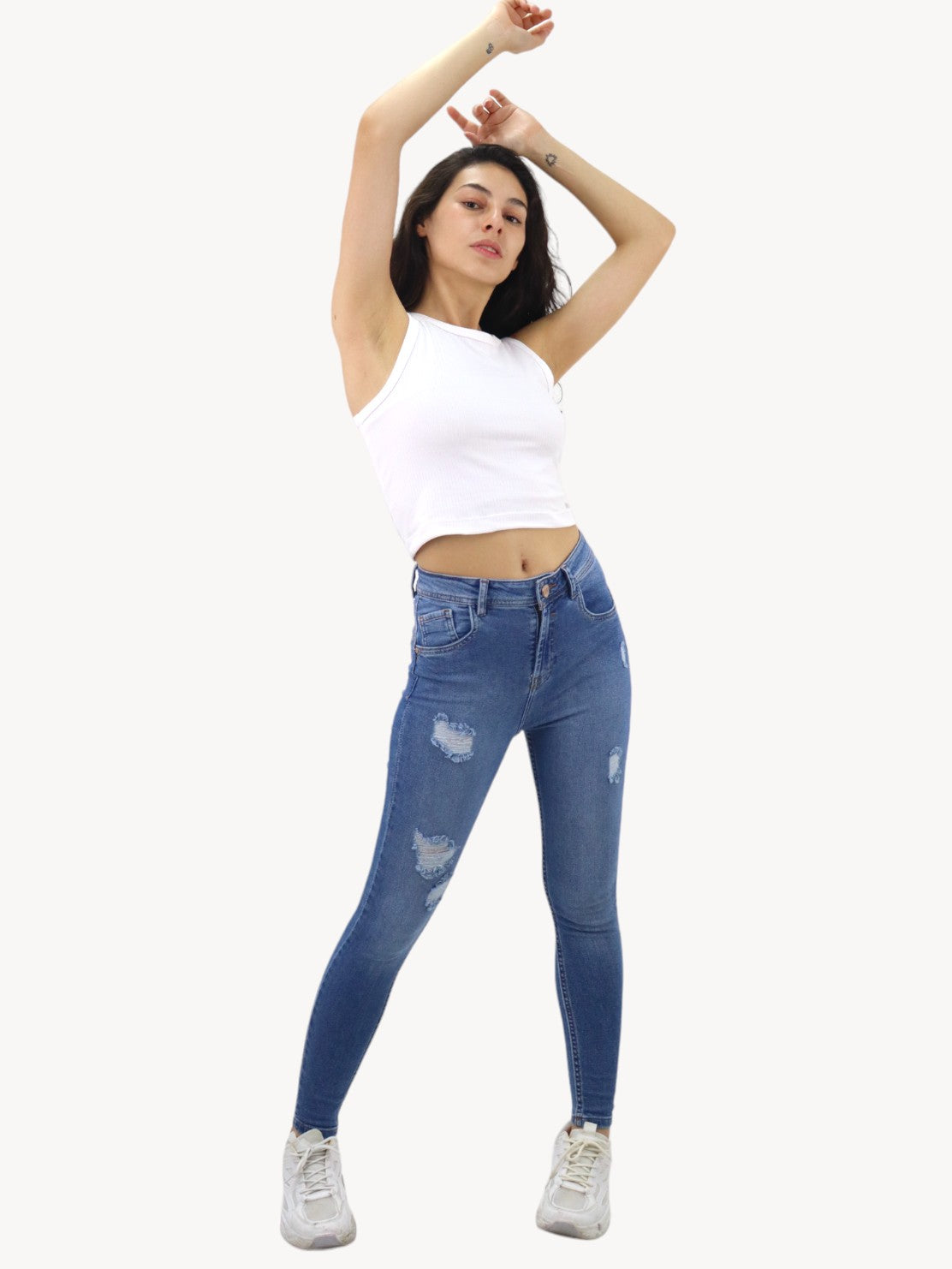 Jeans skinny de color azul medio con destrucción