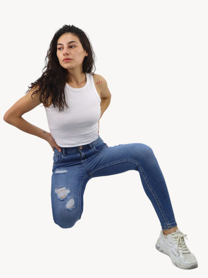 Jeans skinny de color azul medio con destrucción