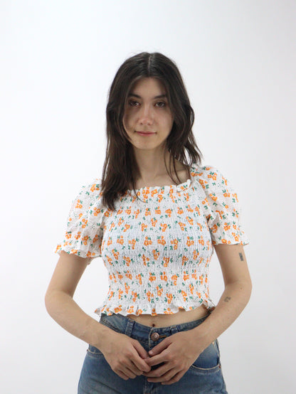 Blusa corta con estampado floral de manga farol con nudo delantero