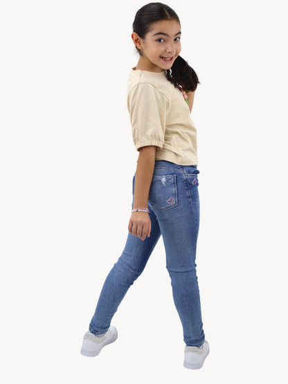 Jeans skinny con destrucción azul medio