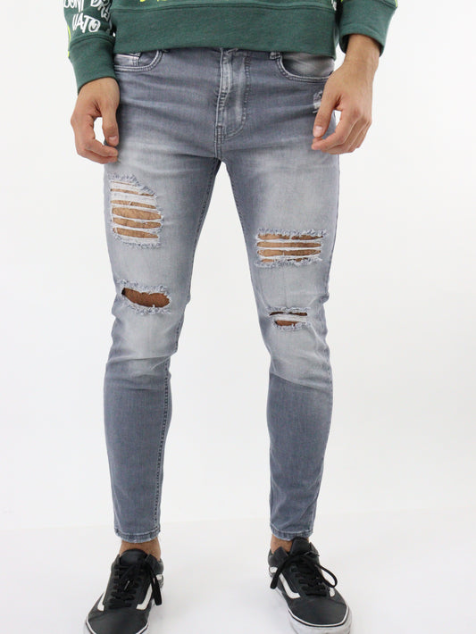 Jeans skinny de color gris con destrucción